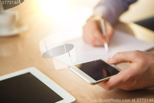 Image of The male hand holding a phone 