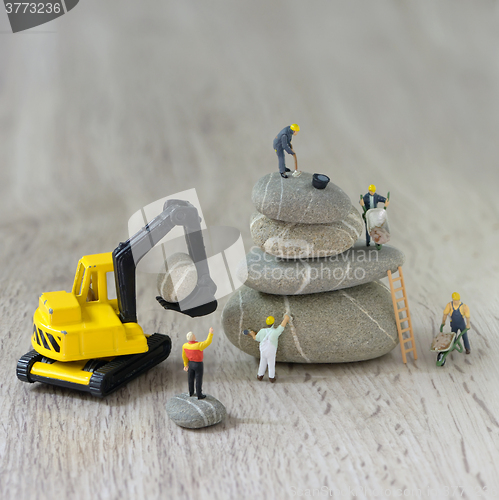 Image of Construction site with miniature workers