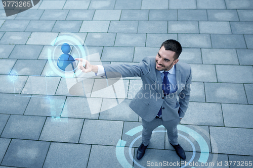 Image of young smiling businessman outdoors from top