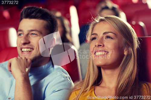 Image of happy friends watching movie in theater