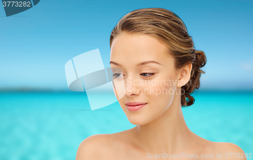 Image of smiling young woman face and shoulders