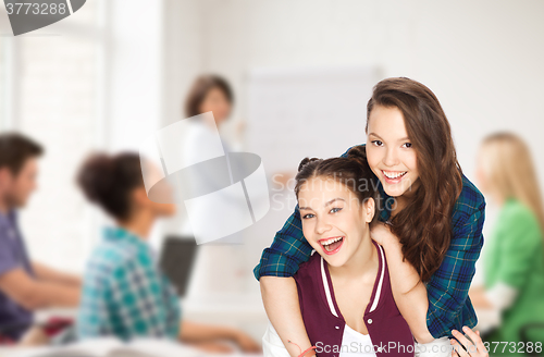 Image of happy pretty teenage girls having fun at school