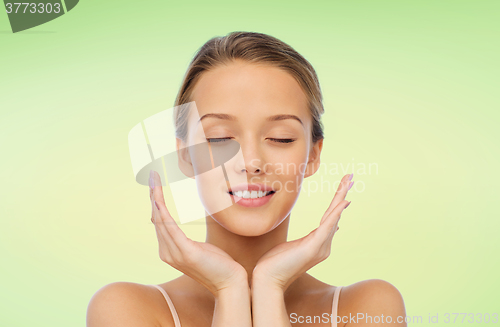 Image of smiling young woman face and hands