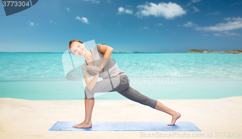 Image of woman making yoga low angle lunge pose on mat