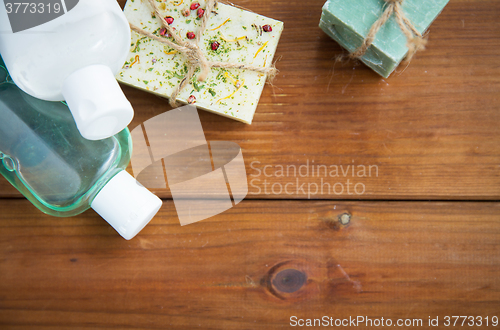 Image of close up of handmade soap bars and lotions on wood