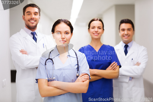 Image of happy group of medics or doctors at hospital