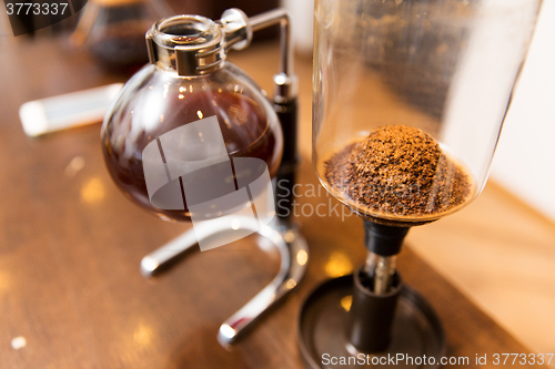 Image of close up of siphon vacuum coffee maker at shop