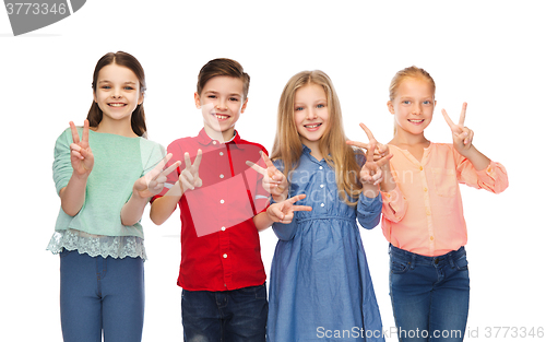 Image of happy boy and girls showing peace hand sign