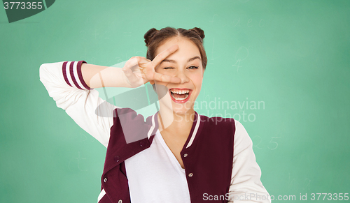 Image of happy teenage student girl showing peace sign