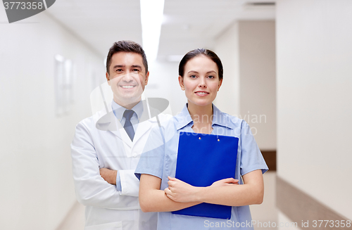 Image of smiling medics at hospital with clipboard