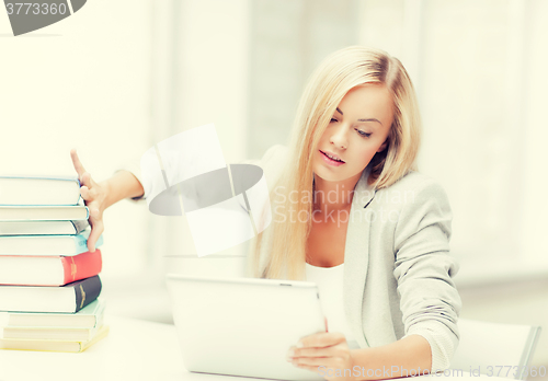 Image of student with books and tablet pc