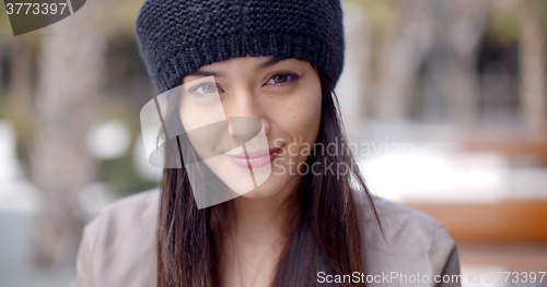 Image of Pretty thoughtful young woman in a woolly cap