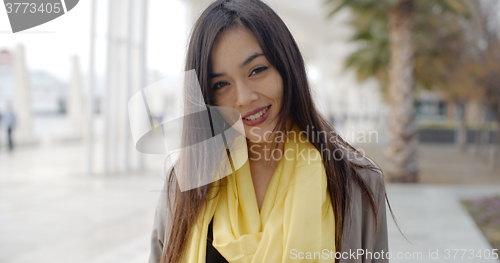 Image of Joyful grinning woman outside in yellow scarf