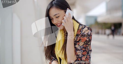 Image of Young woman listening to a call on her mobile