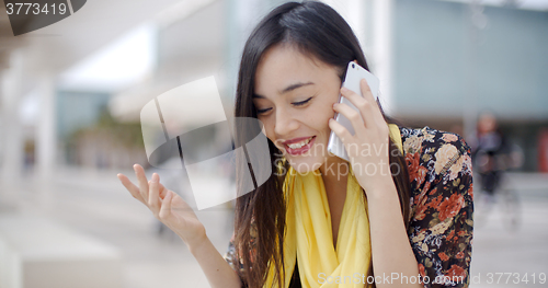 Image of Smiling happy woman using a mobile phone