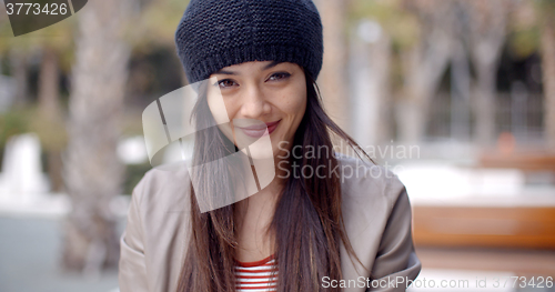 Image of Pretty thoughtful young woman in a woolly cap