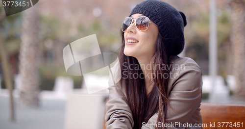 Image of Gorgeous young woman sitting daydreaming