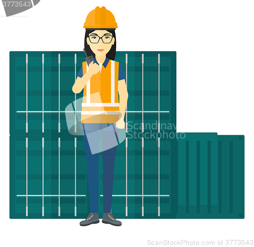 Image of Stevedore standing on cargo containers background.