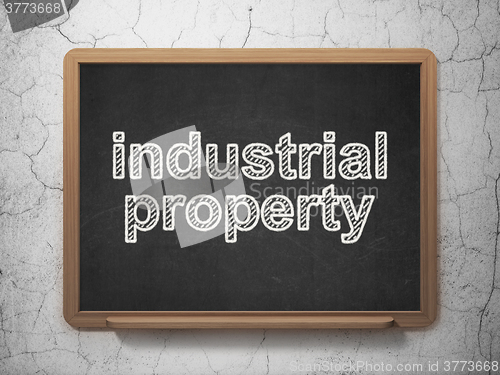 Image of Law concept: Industrial Property on chalkboard background