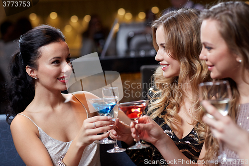 Image of happy women with drinks at night club