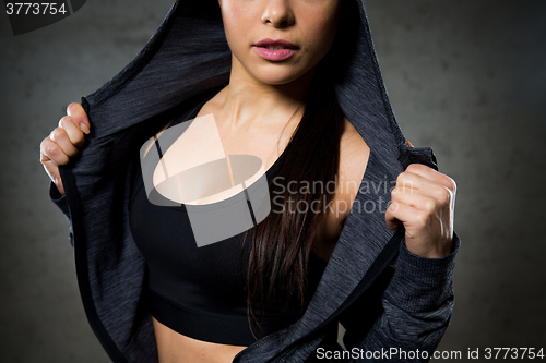 Image of close up of woman posing and showing sportswear