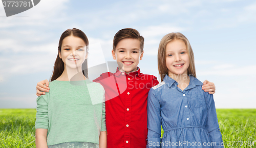 Image of happy boy and girls hugging