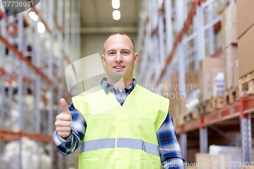 Image of happy man showing thumbs up gesture at warehouse