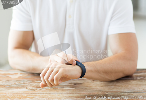 Image of close up of man with heart-rate watch