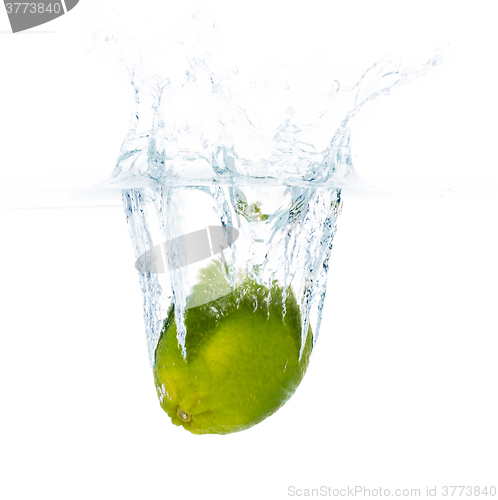 Image of lime falling or dipping in water with splash