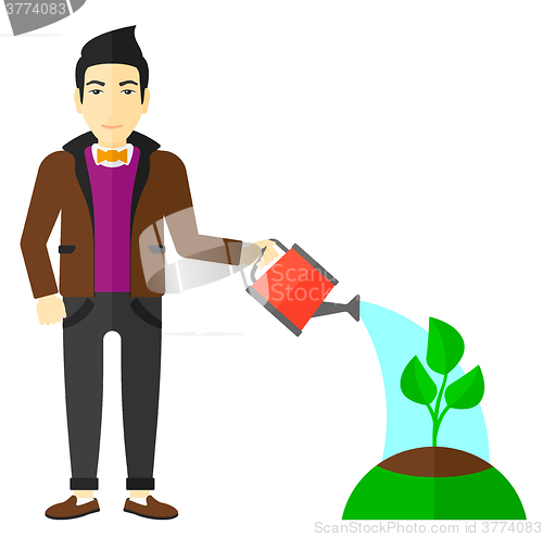 Image of Man watering tree.