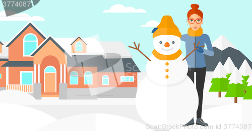 Image of Woman posing near snowman.
