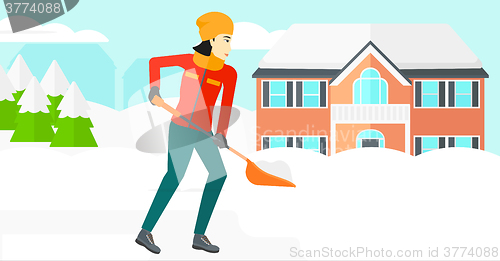 Image of Woman shoveling and removing snow.