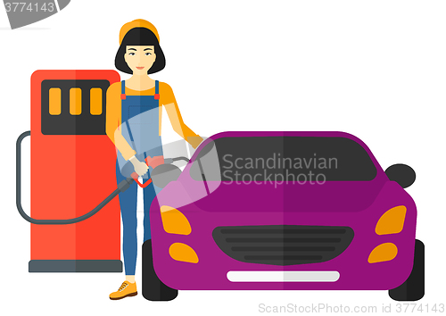 Image of Woman filling up fuel into car.