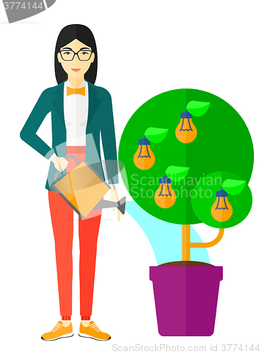 Image of Woman watering tree with light bulbs.