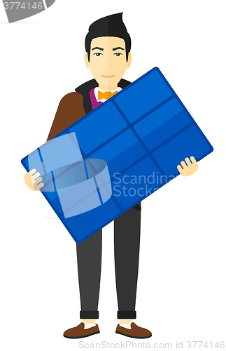 Image of Man holding solar panel.