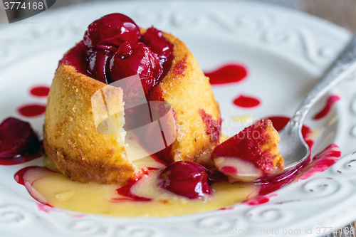 Image of White chocolate fondant with cherry sauce.