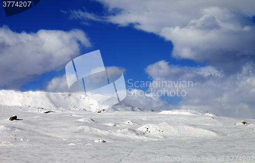 Image of Ice-covered slope and snowy mountains in fog