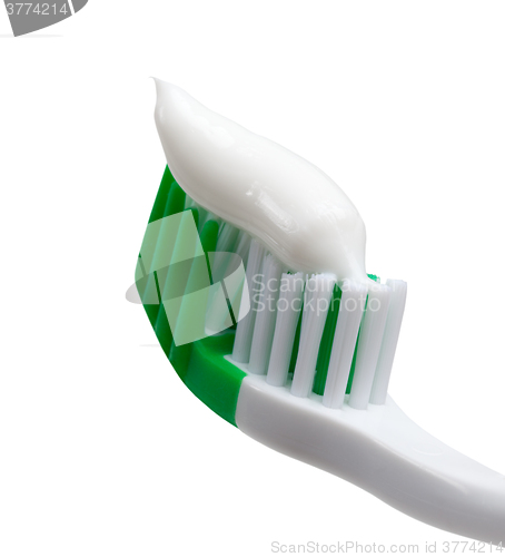 Image of Green toothbrush with toothpaste