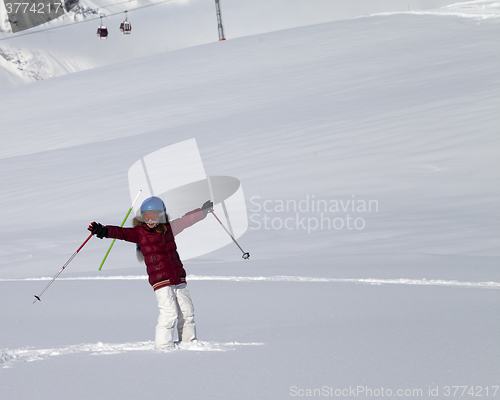 Image of Happy girl on off-piste slope after snowfall at nice sun day