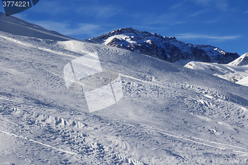 Image of Off-piste slope at sun windy day