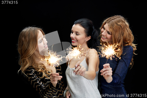 Image of happy young women dancing at night club disco