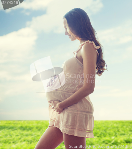 Image of happy pregnant woman in chemise