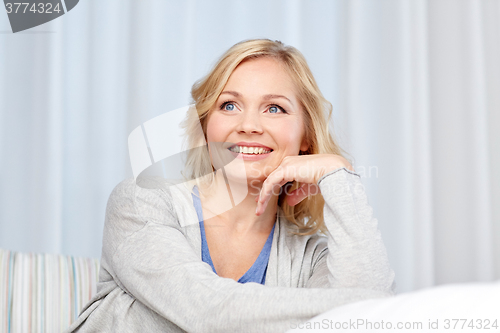 Image of happy middle aged woman at home