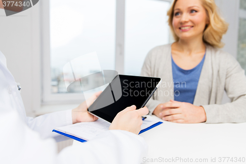 Image of doctor with tablet pc and woman at hospital