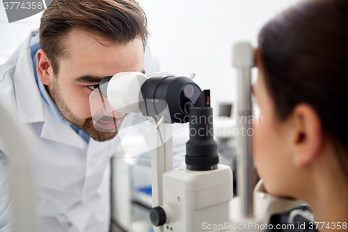 Image of optician with tonometer and patient at eye clinic