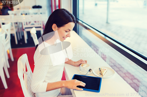 Image of smiling woman with tablet pc and coffee at cafe