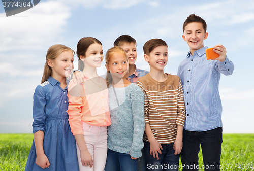 Image of happy children talking selfie by smartphone