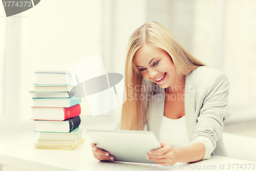 Image of student with books and tablet pc