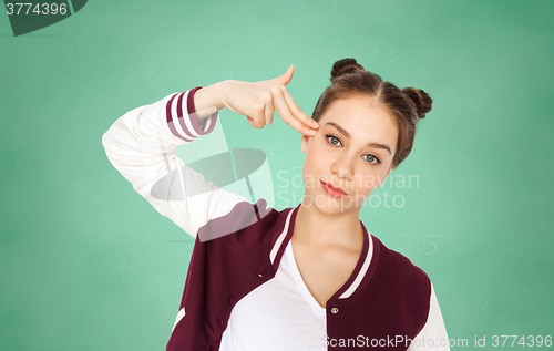 Image of bored student girl making finger gun gesture