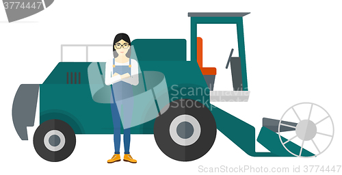 Image of Woman standing with combine on background.